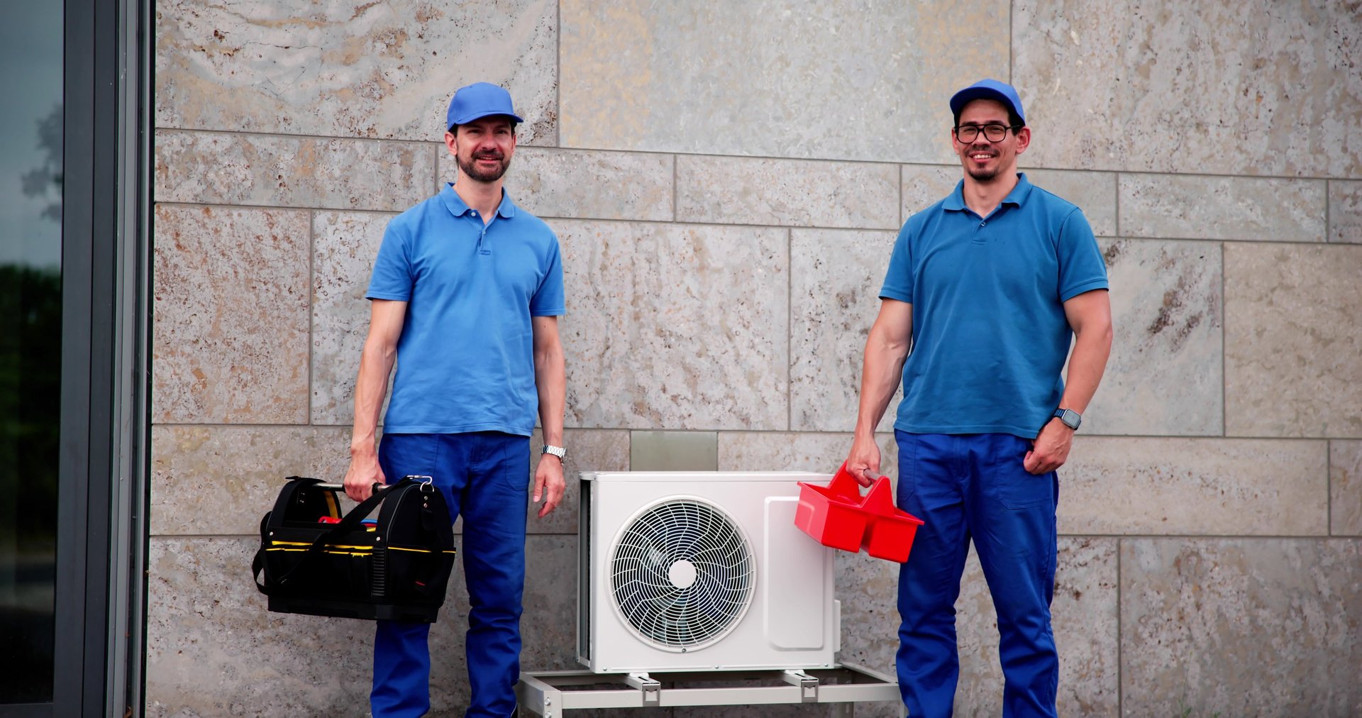 Professional HVAC technicians working together