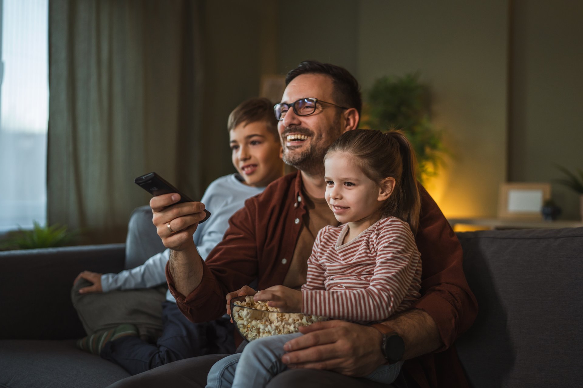 Family enjoying a cozy movie night at home